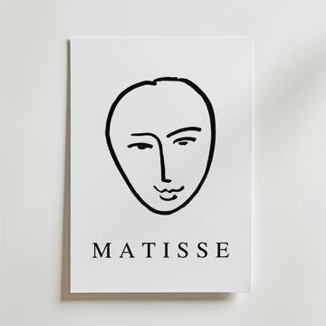 Minimal Matisse Poster by Bozetto har ett minimalistiskt svart linjeansikte på en vit bakgrund med fet "MATISSE" text, tryckt på premiumpapper med en matt finish för en elegant look.