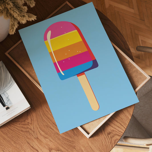 The no-9 poster features a vibrant striped ice cream popsicle on a blue background, displayed on a wooden table beside a chair, a book, and a glimpse of a plant in the corner.