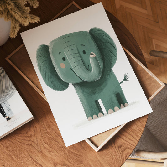 The no-9 features a playful, cartoon-style drawing of a cute, smiling green elephant on paper, set on a wooden table with books and a plant nearby.