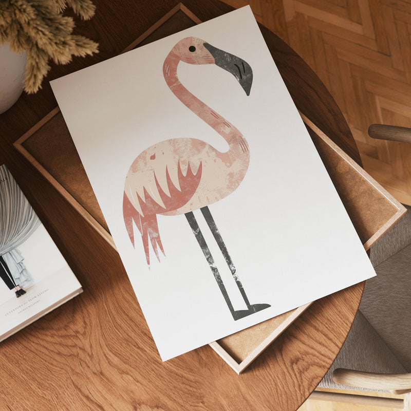 A minimalist illustration of no-9, a pink flamingo, is printed on a white sheet of paper resting on a wooden table next to a book and a potted plant.