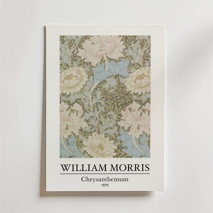 Bozetto William Morris Chrysanthemum Poster visar den intrikata blomsterdesignen från 1876 i mjukt grönt, krämfärgat och blått på en himmelsblå bakgrund med texten "WILLIAM MORRIS Chrysanthemum 1876" under bilden.