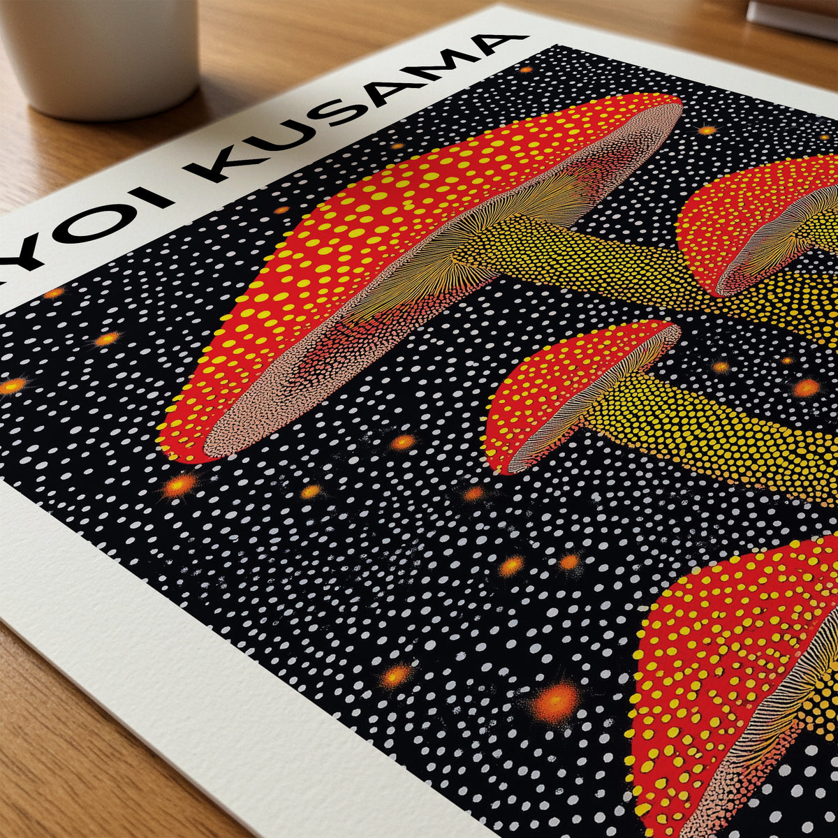 Yayoi Kusama Mushrooms poster liggande på skrivbord – Bozetto paper on desk i hög tryckkvalitet